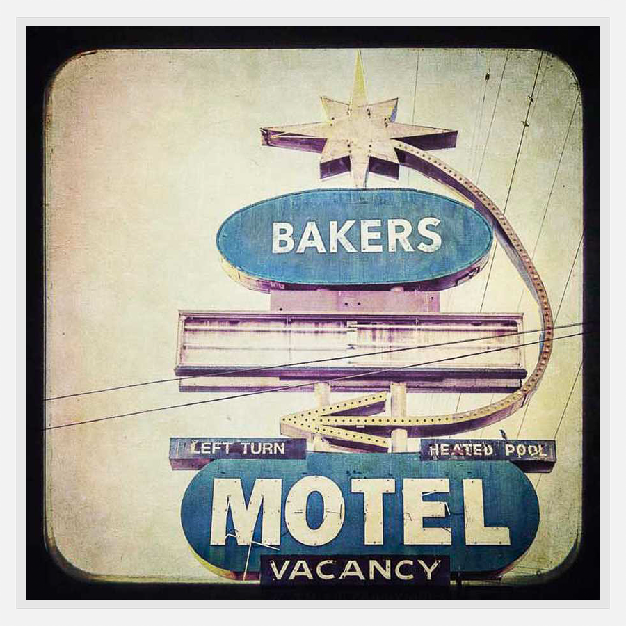 A vintage motel sign evokes a sense of nostalgia with its faded colors and retro design. The artwork captures the essence of a bygone era, offering a unique piece of wall decor with a touch of mid-century charm.